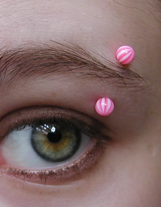 Curved barbell through the outer eyebrow — reference photo