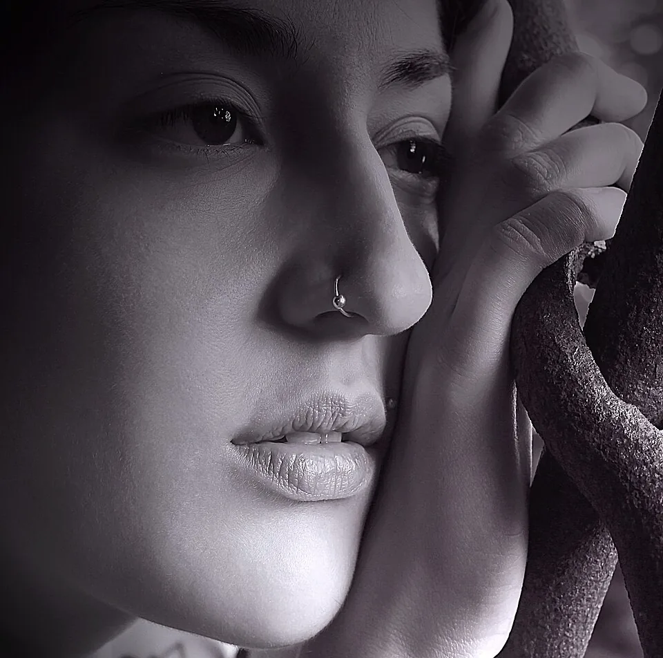 Small silver ring through the side of the nose — reference photo