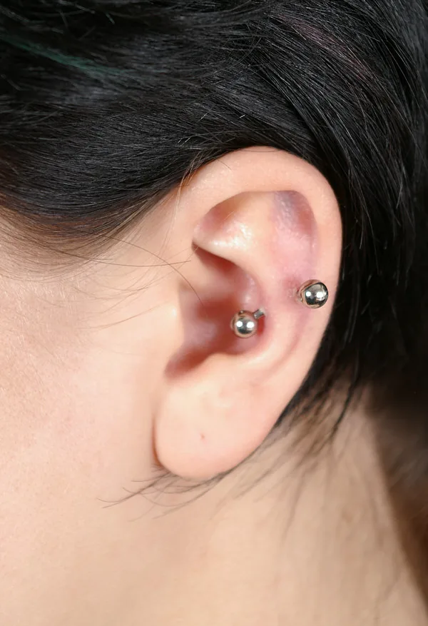 Barbell through the inner cartilage ridge of the ear — reference photo